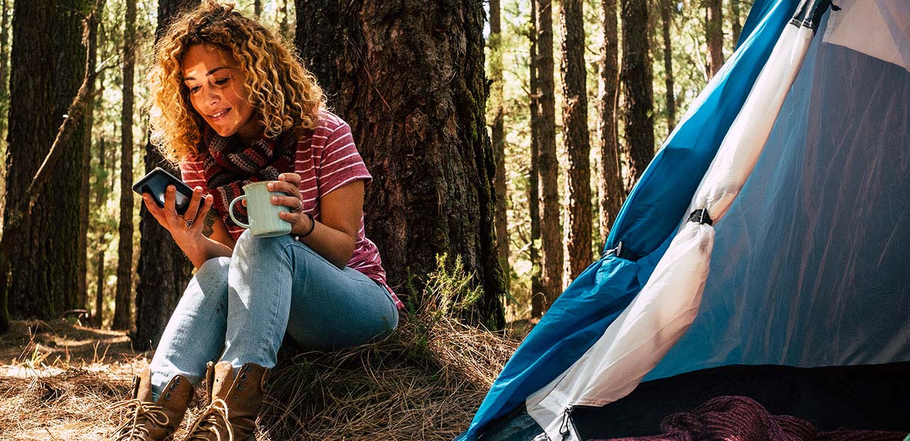 Woman camping in the woods